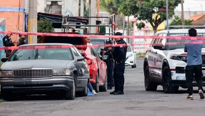 Patrullas de la policía municipal acordonan con cinta amarilla la calle 3-E tras el ataque a un comerciante en Bosques de San Sebastián, Puebla.